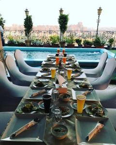 a long table with plates of food and drinks at Hotel Royal Marshal in Cairo
