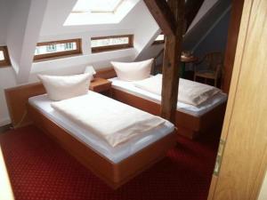 a room with two beds in a room at La Rustica Altstadthotel in Wernigerode