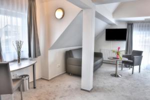 a living room with a couch and a table at Fast Lane Hotel in Barweiler