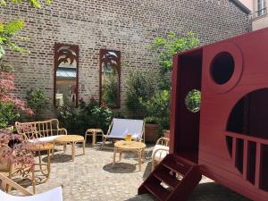 a patio with chairs and tables and a brick wall at ibis Styles Paris Nation Cours de Vincennes in Paris