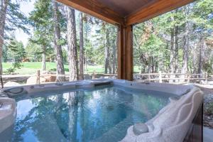 a large swimming pool in a porch with trees at Woodwinds 25 in Mammoth Lakes