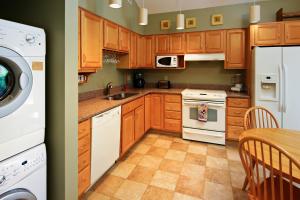 a kitchen with wooden cabinets and a white appliance at Summerwind Cottage 1140 in Seabrook Island +32 photos