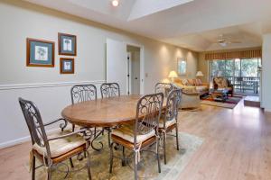 a dining room with a table and chairs at Summerwind Cottage 1140 in Seabrook Island