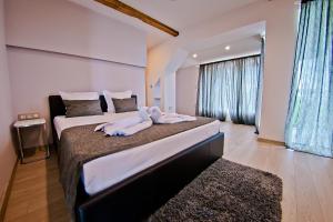 a bedroom with two beds with towels on them at Hotel Amfora in St. St. Constantine and Helena