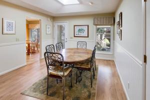 a dining room with a wooden table and chairs at Summerwind Cottage 1140 in Seabrook Island