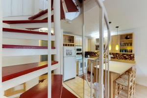 a kitchen with a spiral staircase in a house at Brighton Condo #208 in Girdwood