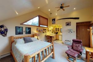 a bedroom with a bed and a ceiling fan at Crow Creek in Girdwood