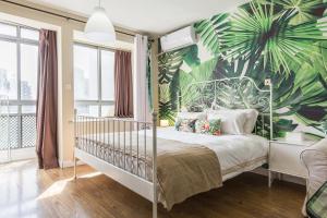 上海市にあるSidihome Selected City Apartmentのベッドルーム1室(トロピカルな壁紙のベッド1台付)