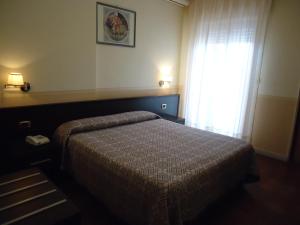 Postel nebo postele na pokoji v ubytování Hotel Riviera