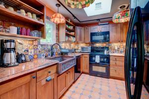 a large kitchen with wooden cabinets and appliances at Vintage Rockport Escape in Rockport