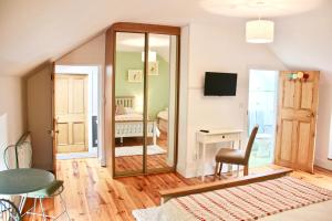 a living room with a mirror and a bedroom at Riverside House in Newport