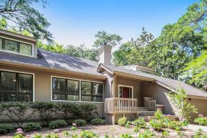 a home with a porch and a house at Baywood Luxury in Seabrook Island