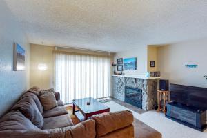 a living room with a couch and a fireplace at Brighton Condo #209 in Girdwood