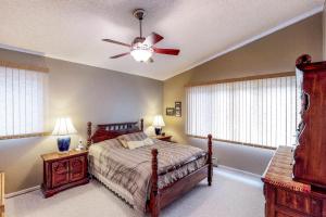 a bedroom with a bed and a ceiling fan at Brighton Condo #209 in Girdwood