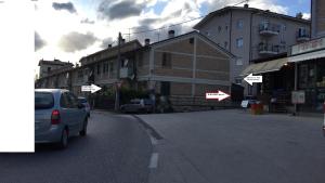 a car parked on the side of a street with buildings at Itaka in LʼAquila