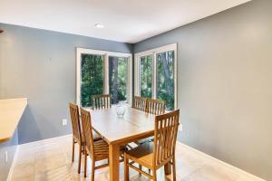 a dining room with a wooden table and chairs at Baywood Luxury in Seabrook Island +32 photos