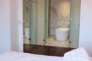 a bathroom with a tub and a large glass door at Residence Master Suite en Porteño Building in Buenos Aires +21 photos