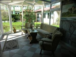 a screened in porch with a couch and a table at Anker Kotwica in Łeba