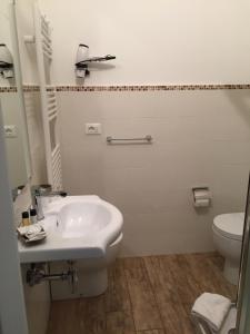 a bathroom with a sink and a toilet at Itaka in LʼAquila