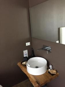 a bathroom with a white sink and a mirror at Itaka in LʼAquila