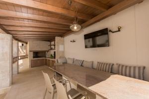 a dining room with a large wooden table and chairs at Villa Hurem in Trogir