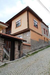 a house with a cobblestone street in front of it at **ETNO Vila** - KRUSEVO in Kruševo