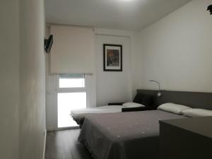 Cama o camas de una habitación en Hotel Alguer Camp Nou