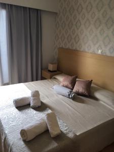 Postel nebo postele na pokoji v ubytování Aphrodite Hotel Syros