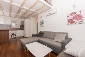 a living room with a couch and a kitchen at Villa Hurem in Trogir