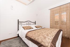 a bedroom with a large bed and a window at Villa Hurem in Trogir +19 photos