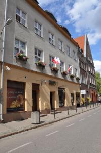 a building on the side of a street at Amber Apartments in Gdańsk