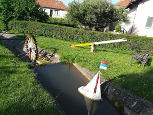 a small boat and a toy boat in the water at Apartman "Vienna" in Soko Banja