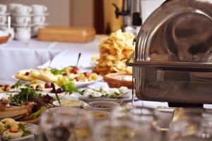 a buffet with plates of food on a table at Dwór Nad Bugiem in Majdan Stulenski