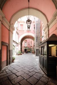an empty street with an archway in a building at Toledo 16 Luxury Suites in Naples