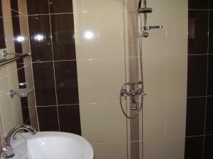 a bathroom with a shower with a toilet and a sink at Guest House Goranovi in Velingrad +18 photos