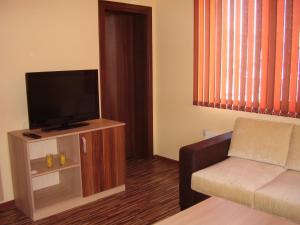 a living room with a couch and a flat screen tv at Guest House Goranovi in Velingrad
