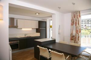 a kitchen with a black table and chairs at Villa Cattina in Seeboden