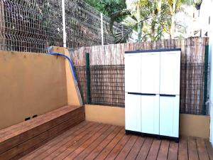 a white cabinet sitting on a wooden deck at T2 la saline les bains in La Saline Les hauts 