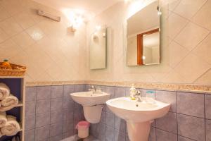 a bathroom with a sink and a mirror at Villa Galanis in Symi