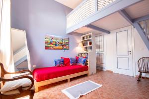 a bedroom with a red bed in a room at Villa Galanis in Symi