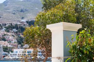 a white pillar with a view of a city at Villa Galanis in Symi