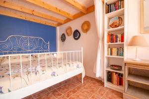 a childs bedroom with a white crib and bookshelves at Villa Galanis in Symi