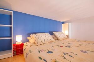 a bedroom with a large bed with a blue wall at Villa Galanis in Symi