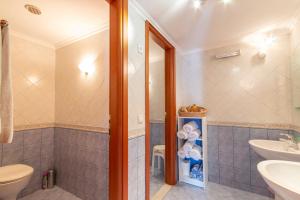 a bathroom with a toilet and a sink at Villa Galanis in Symi