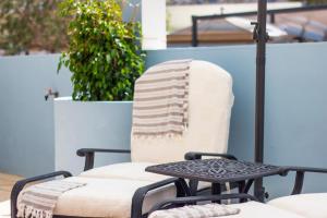 a chair and a table on a patio at Villa Galanis in Symi