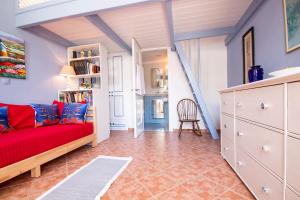 a living room with a red couch and a table at Villa Galanis in Symi
