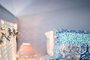 a room with a lamp and a blue and white couch at Villa Galanis in Symi