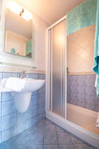 a bathroom with a sink and a shower at Villa Galanis in Symi