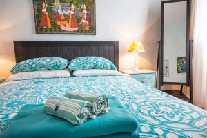 a bedroom with a bed with two towels on it at Villa Galanis in Symi