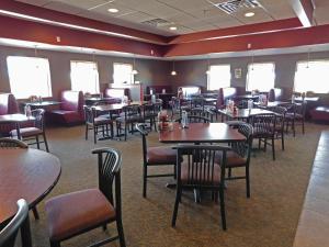 a dining room filled with tables and chairs at Days Inn by Wyndham Fargo/Casselton in Casselton
